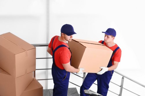 Furniture pick-up team loading office desks and chairs for recycling