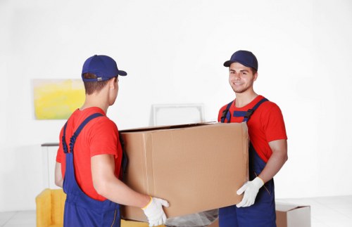 Professional piano removals team preparing an upright piano for safe transport
