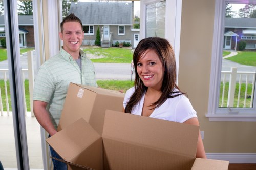 House removals team loading furniture into a van