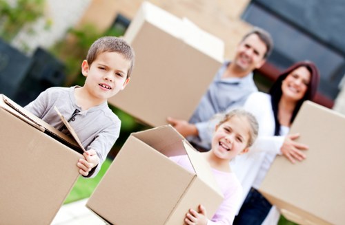 Professional movers carrying items during a same day removal job