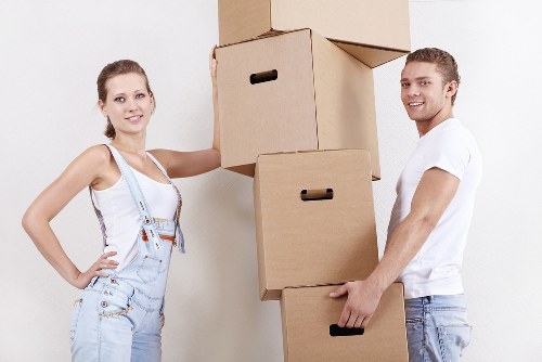 Removal team carrying a large wardrobe during a UK home move